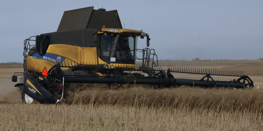 Harvesting field in New Holland combine